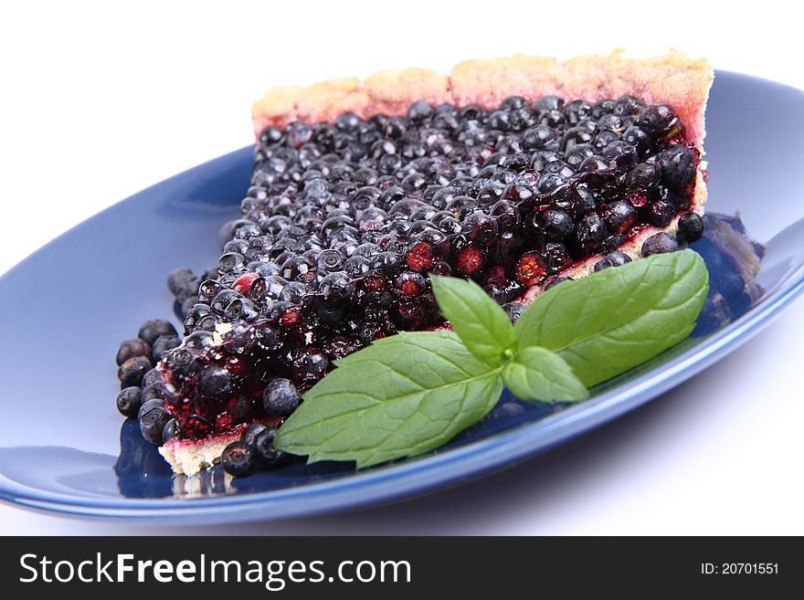 Blueberry Tart: a portion on a plate decorated with mint