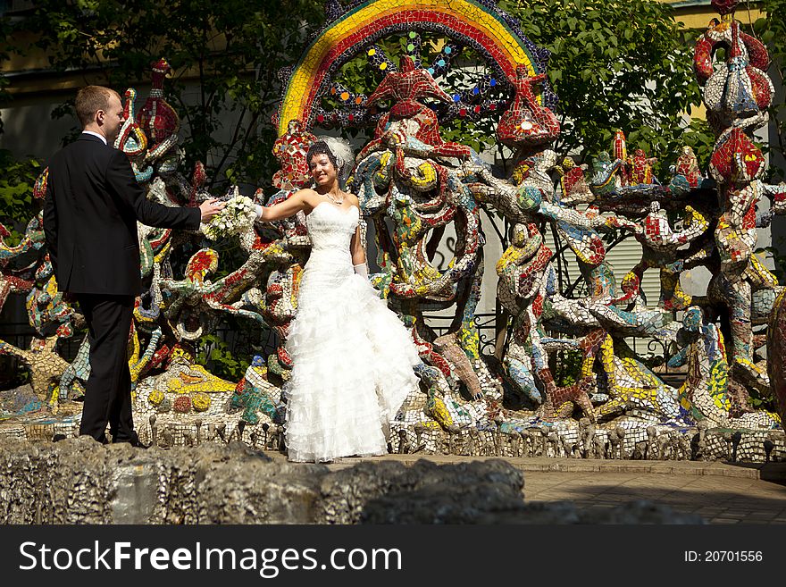 Bride and groom standing at the colorful walls. Bride and groom standing at the colorful walls