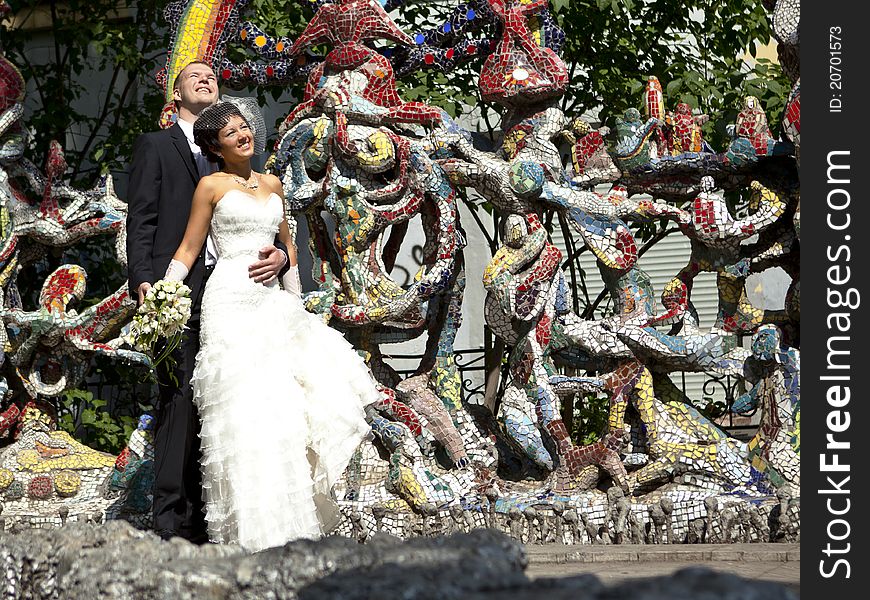 Bride and groom standing at the colorful walls. Bride and groom standing at the colorful walls