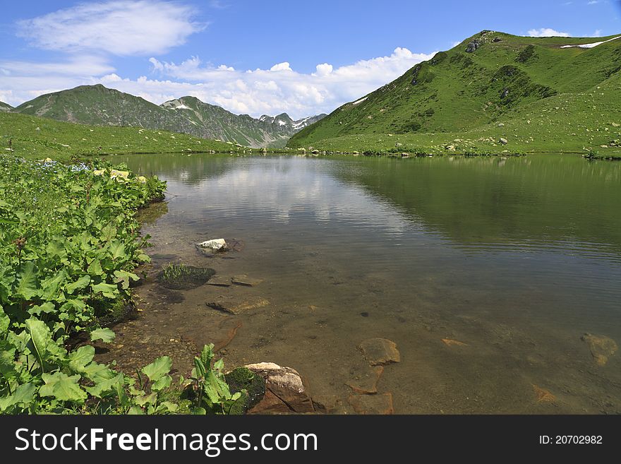 Mountain lake with reflection of clouds, Abkhazia