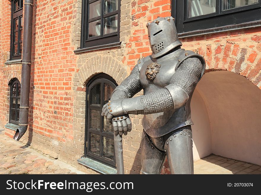 As if forming the aura of old time the sculpture of knight costs in the court of fortress.