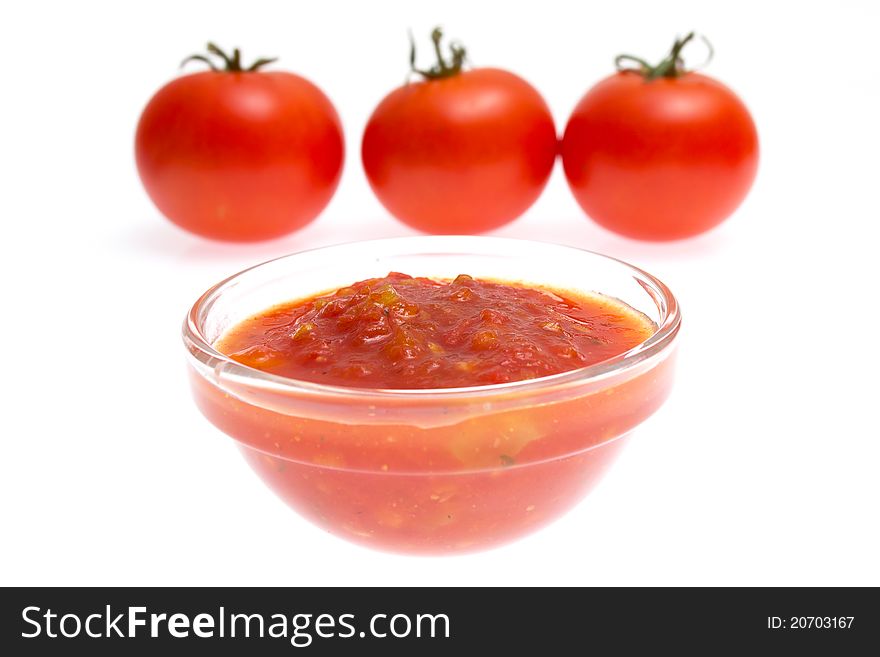 Ketchup and tomato on white