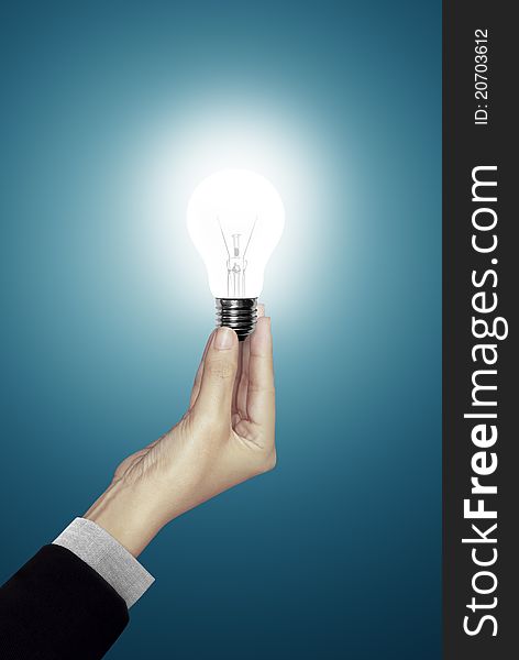 Blue background of Bulb light in woman hand