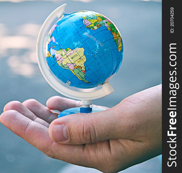 Model of the planet earth in the hands of. Model of the planet earth in the hands of