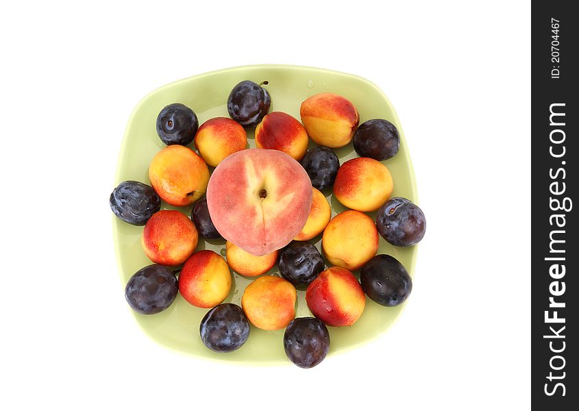 Still life with natural ripe plums and peaches on a white background