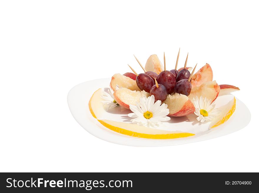 The dessert from fruits, decorated with flowers