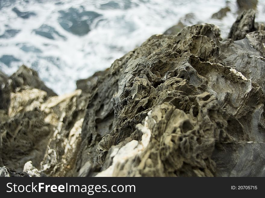 Close up view of the coastal rocks along the Cinque Terre coast in Italy.