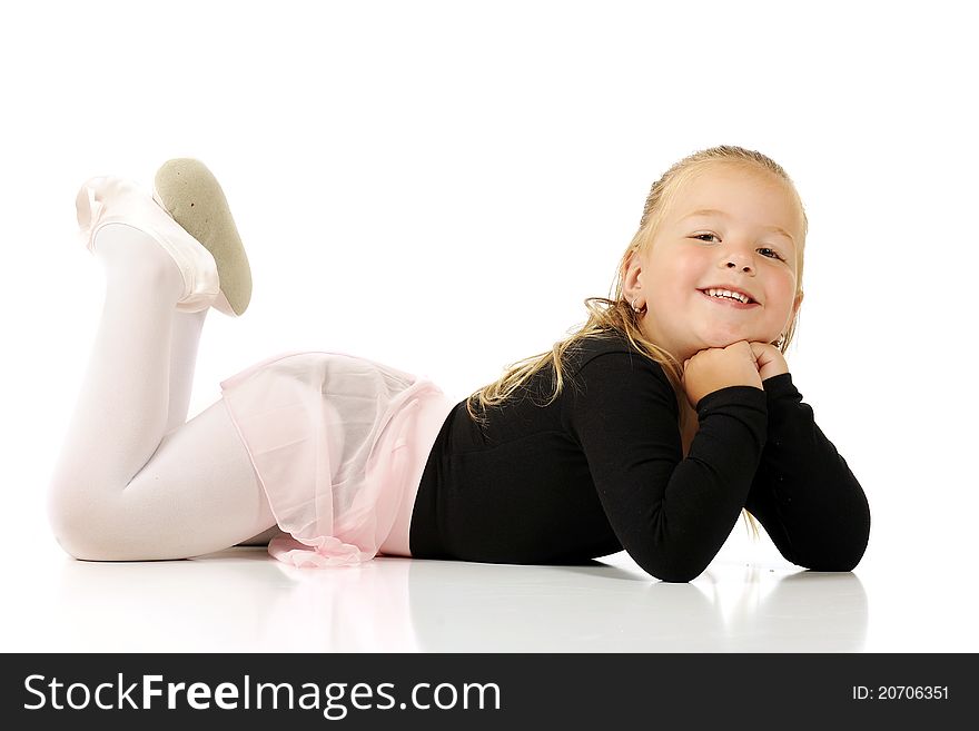 A beautiful preschool ballerina laying on her belly. Isolated on white. A beautiful preschool ballerina laying on her belly. Isolated on white.