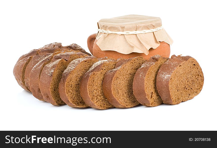Loaf of bread and pot on white background