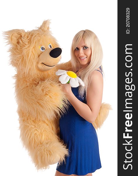 Beautiful model with a bear in hands on a white background