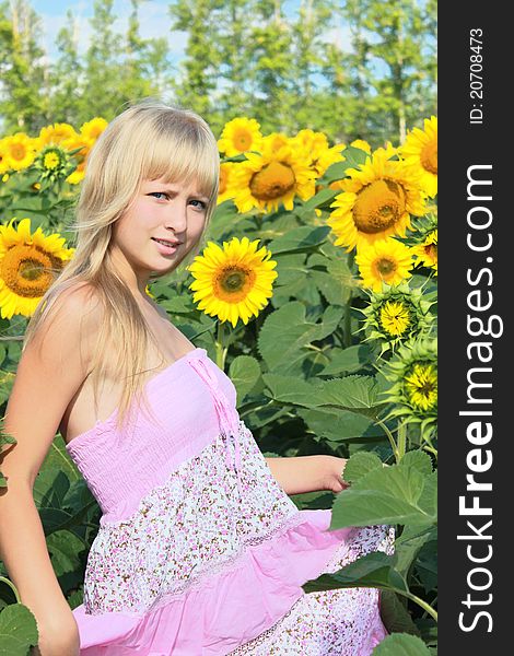 A girl among sunflowers field