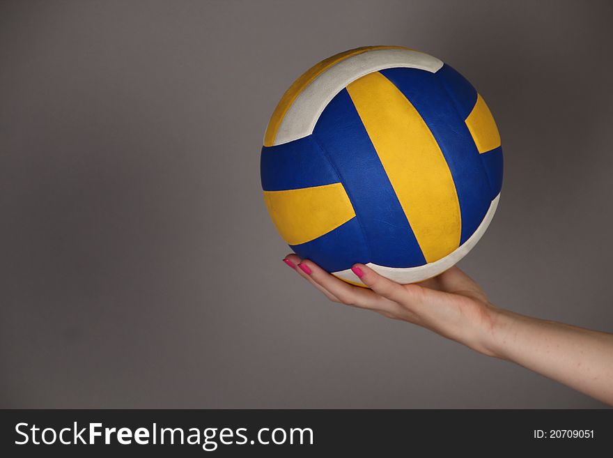 Yellow And Dark Blue Ball In A Hand