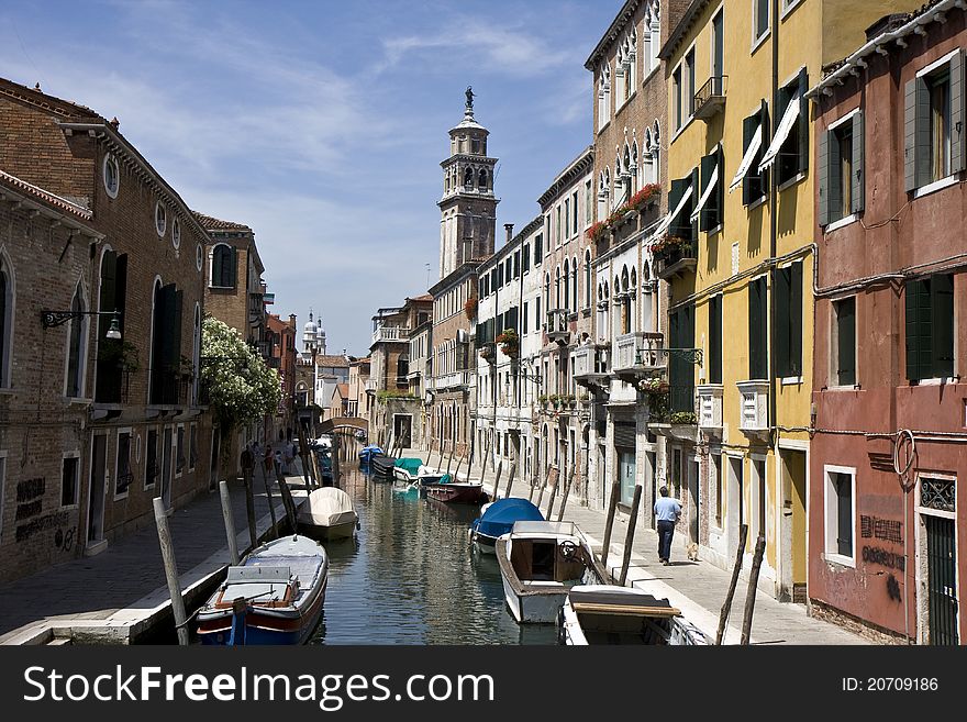 Buildings on a canal of Venice, and parked boats in Italy. Buildings on a canal of Venice, and parked boats in Italy