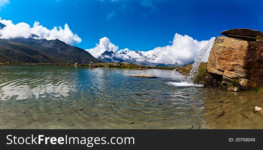 A panorama of a mountain lake in Wallis, Switzerland