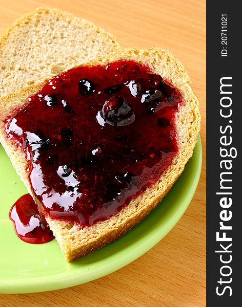 Bread and jam in a green plate. Bread and jam in a green plate