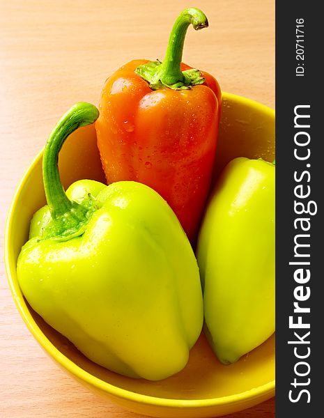 Raw ripe peppers on a wooden table. Raw ripe peppers on a wooden table