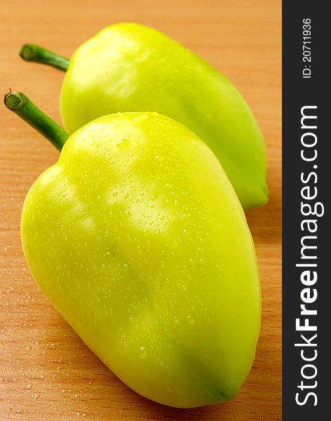 Raw ripe peppers on a wooden table. Raw ripe peppers on a wooden table