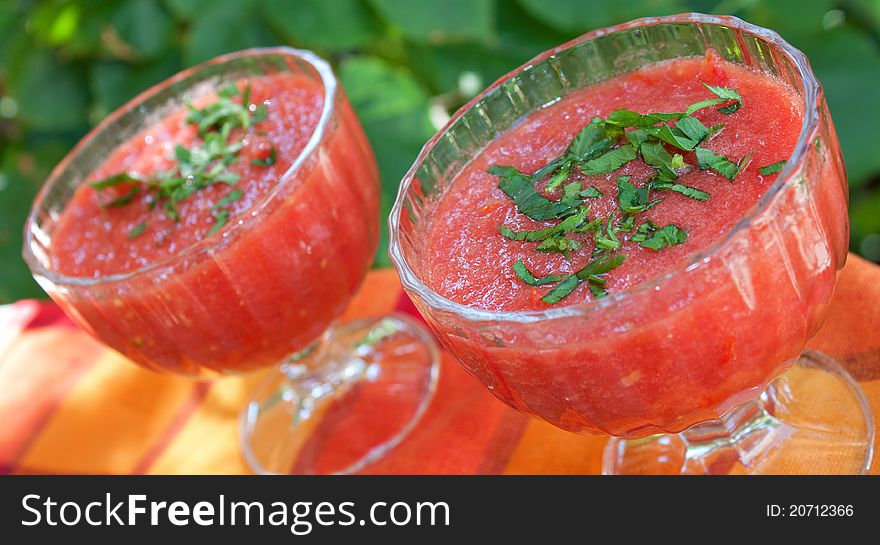 Tomato sauce in glasses with green background