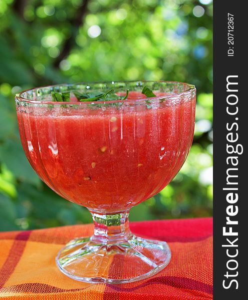 Tomato sauce in glasses with green background