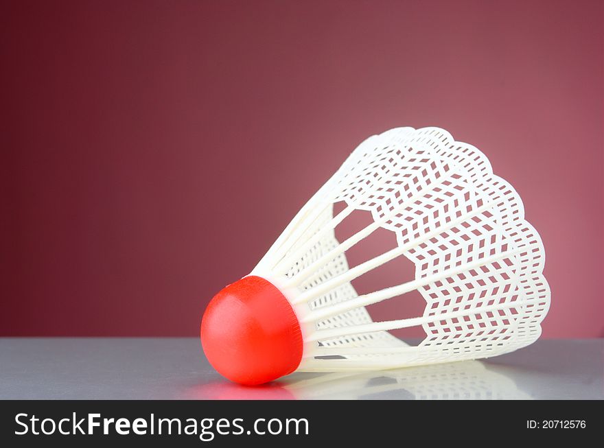 White shuttlecock on a violet background. White shuttlecock on a violet background