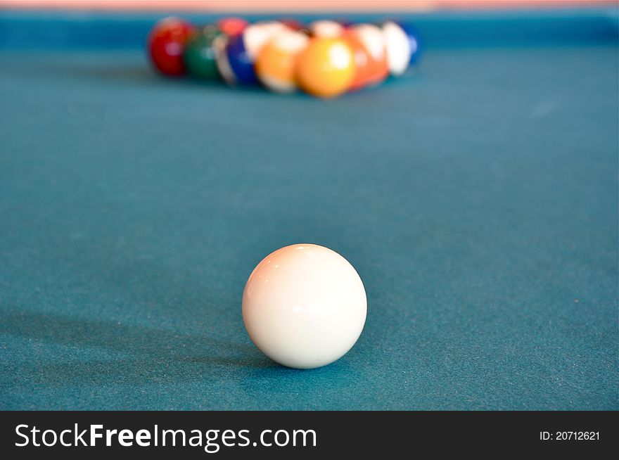 Cue ball with rack of pool balls in the background. Cue ball with rack of pool balls in the background