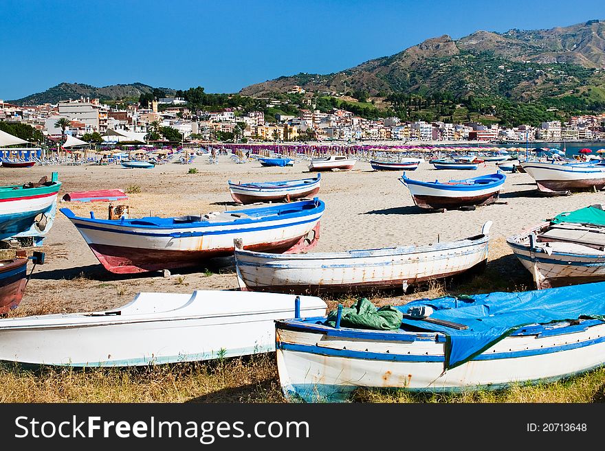 Old boats on  beach Gardini Naxos in summer day, Sicily, Italy. Old boats on  beach Gardini Naxos in summer day, Sicily, Italy