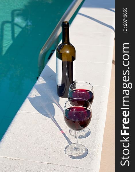 Bottle and glasses with red wine outdoor