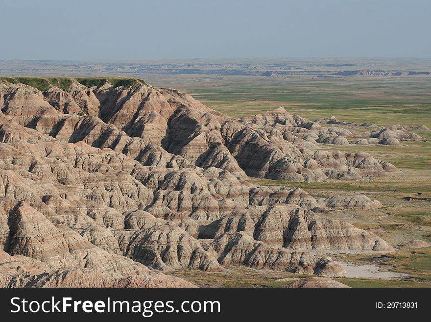 This photograph shows a vast scenic view of the Badlands in South Dakota. This photograph shows a vast scenic view of the Badlands in South Dakota.