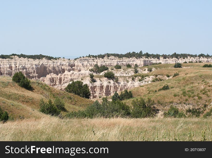 This photograph shows a vast scenic view of the Badlands in South Dakota. This photograph shows a vast scenic view of the Badlands in South Dakota.