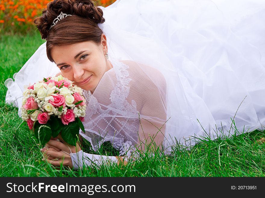 Portrait of a beautiful bride on the grass