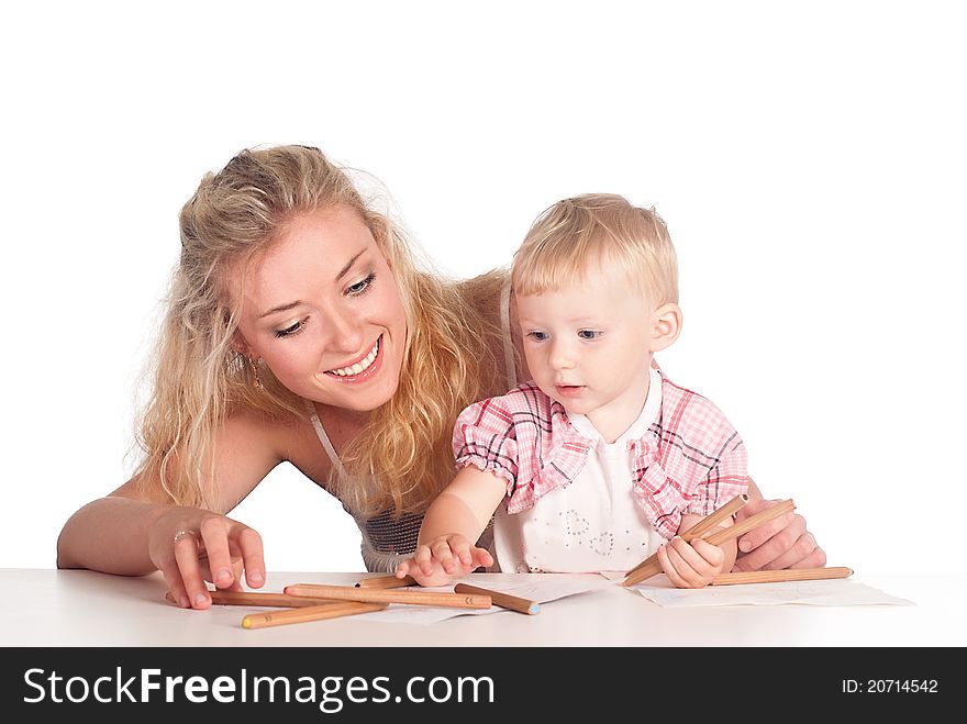 Mom and her daughter drawing at table. Mom and her daughter drawing at table