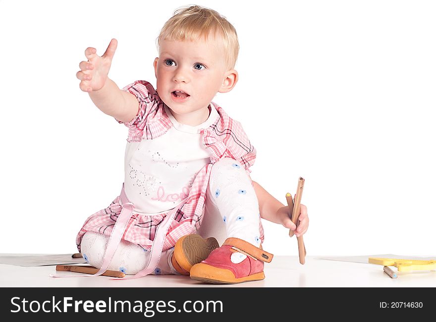 Little girl draws on the floor on white. Little girl draws on the floor on white