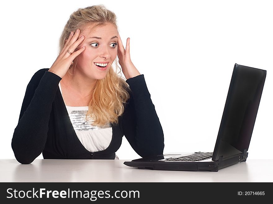 Cute blonde with a laptop at the table. Cute blonde with a laptop at the table