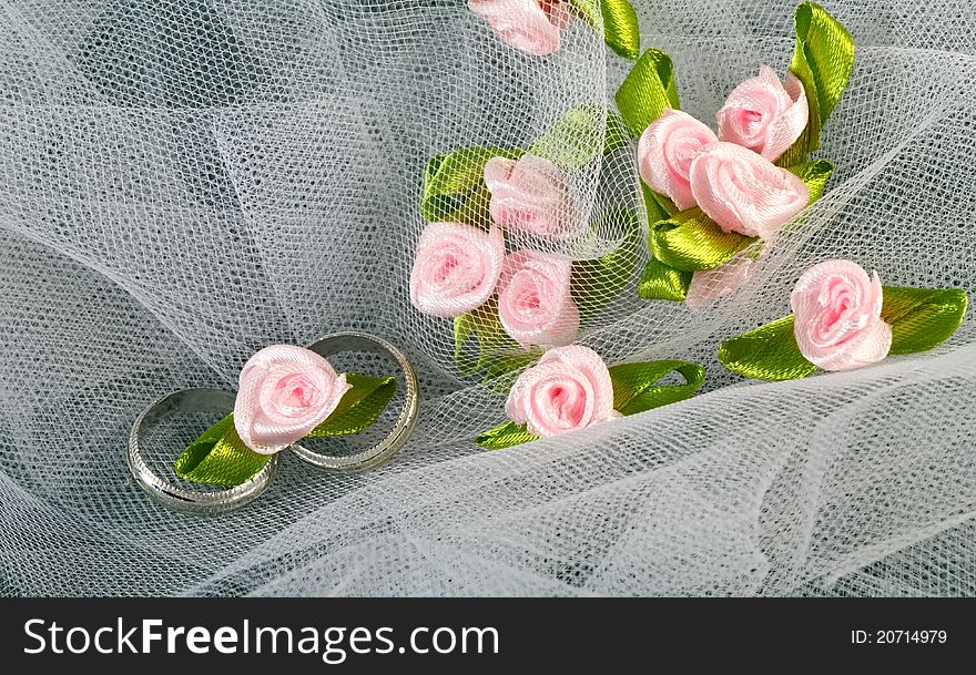 Wedding rings on tulle with pink roses. Wedding rings on tulle with pink roses