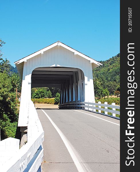 White wooden covered bridge in the countryside. White wooden covered bridge in the countryside
