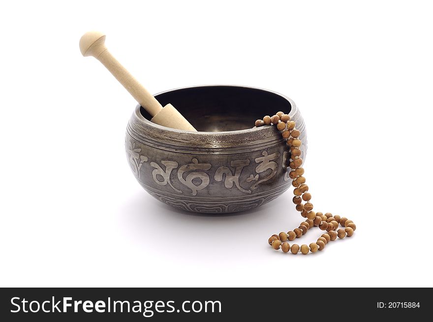Singing bowl and wooden rosary isolated on a plain white background. Singing bowl and wooden rosary isolated on a plain white background.