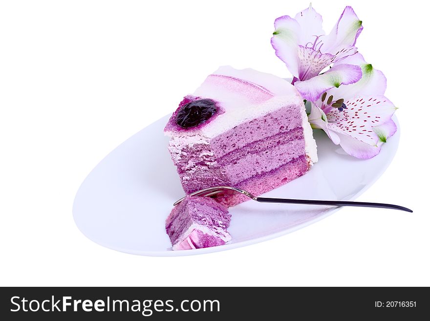 Blueberry cake on a white plate with fork and flower. Blueberry cake on a white plate with fork and flower.