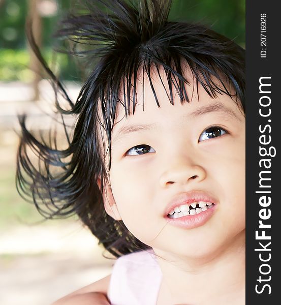 A pink dress girl with messy hair and bad teeth