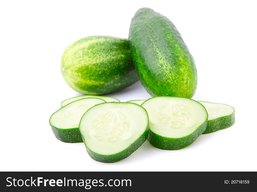 Cucumber and slices over white background.