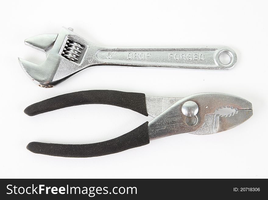Silver and black pliers on white background