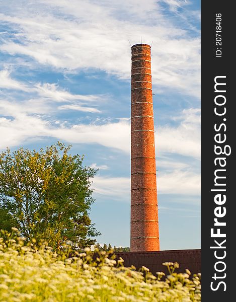 View of old smokestack during sunset time.