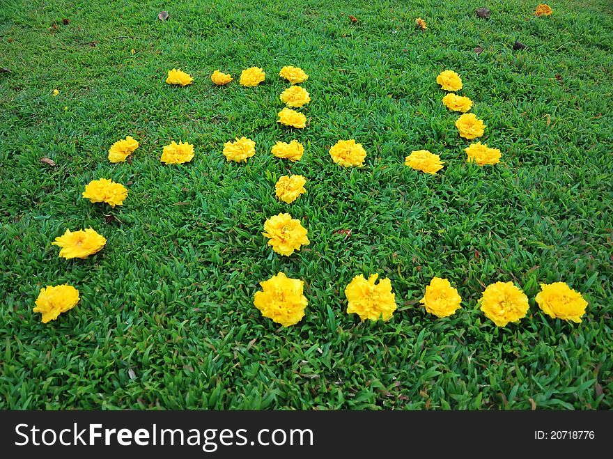 Fresh yellow flowers arranged to form the swastika symbol commonly used in religions such as Hinduism and Buddhism. Fresh yellow flowers arranged to form the swastika symbol commonly used in religions such as Hinduism and Buddhism.