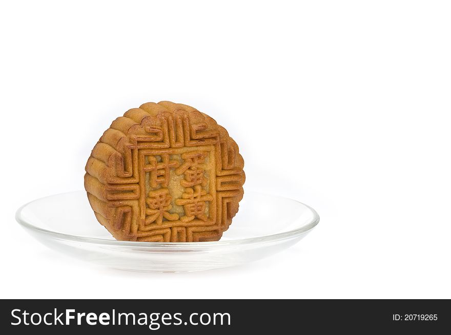 Mooncake on the plate isolated over white background. Mooncake on the plate isolated over white background