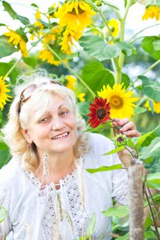 Happy Woman With Flowers In Her Garden Stock Images Happy Woman With Flowers In Her Garden Stock Images