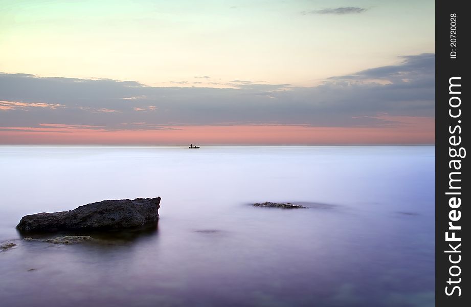 Sea and rock at the sunset. Seascape composition.
