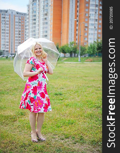 Outdoors portrait of beautiful blond woman in flower dress. Outdoors portrait of beautiful blond woman in flower dress