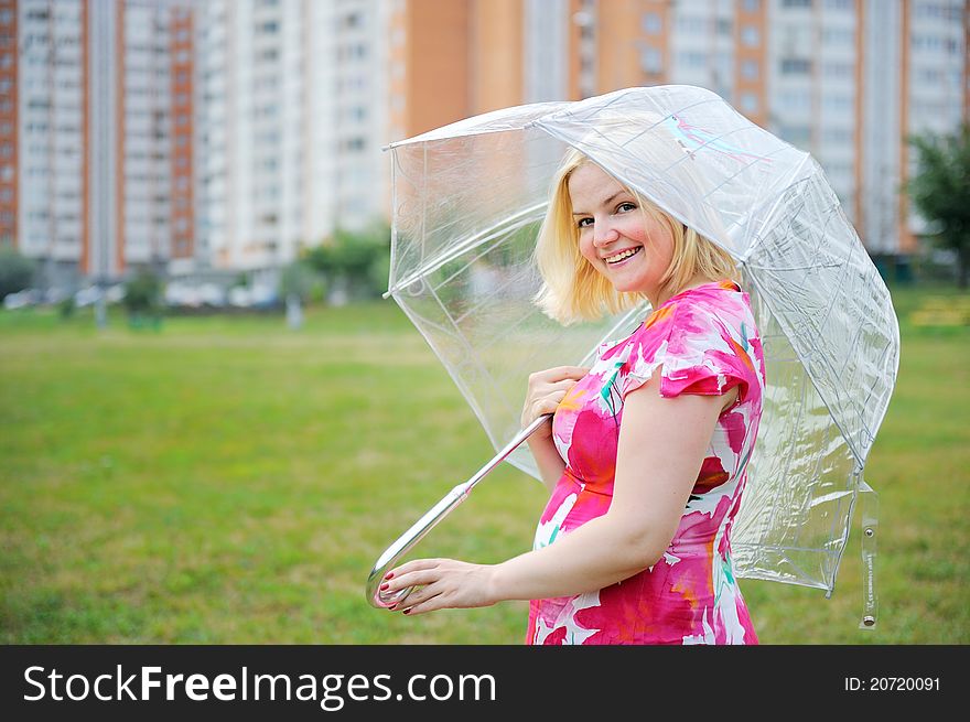 Outdoors portrait of beautiful blond woman in flower dress. Outdoors portrait of beautiful blond woman in flower dress