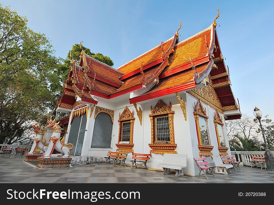 Small religious structure built with golden ornaments and intricately carved designs.