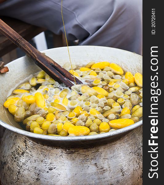 Boiling cocoon in a pot to prepare a cocoon silk