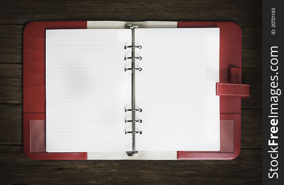 Blank note book on wood background